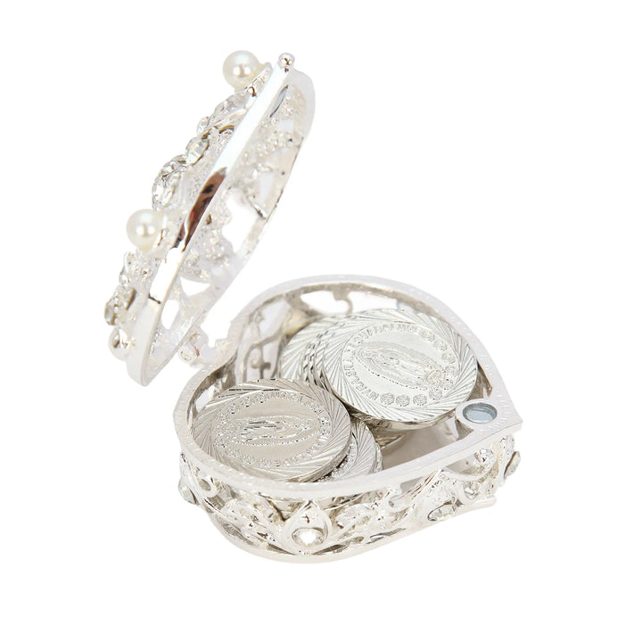 Openwork heart-shaped silver jewelry box with crystal and pearl accents shown open, coins displayed inside and around the box. Features silver-plated Our Lady of Guadalupe coins for devotional décor. Ideal Catholic gift, wedding favor, baptism keepsake, and meaningful spiritual collectible - tingkucoins.com