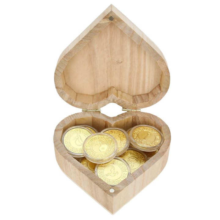 Elegant heart-shaped wooden box with 12 gold-tone engraved coins, perfect as wedding favors, bridal shower gifts, or anniversary keepsakes. Each coin features love-inspired designs, making it a meaningful token for guests and a lasting wedding memory - tingkucoins.com