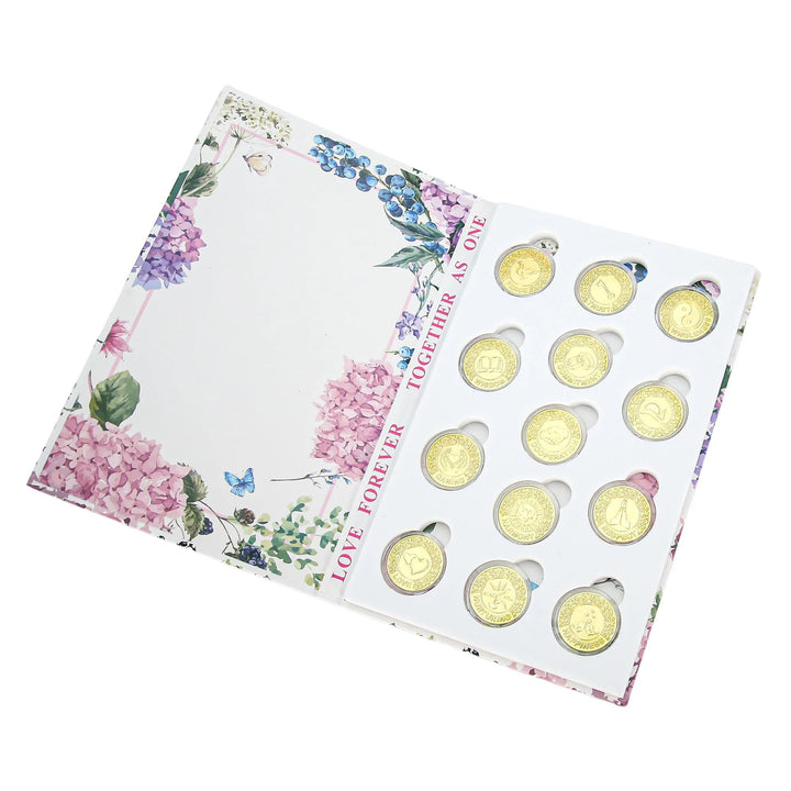 Beautiful 13-piece gold wedding arras coin set presented in a floral box. Each coin carries a unique design symbolizing unity, blessings, and eternal love. Ideal for Catholic and Christian wedding ceremonies, marriage traditions, and as a memorable keepsake or anniversary gift - tingkucoins.com