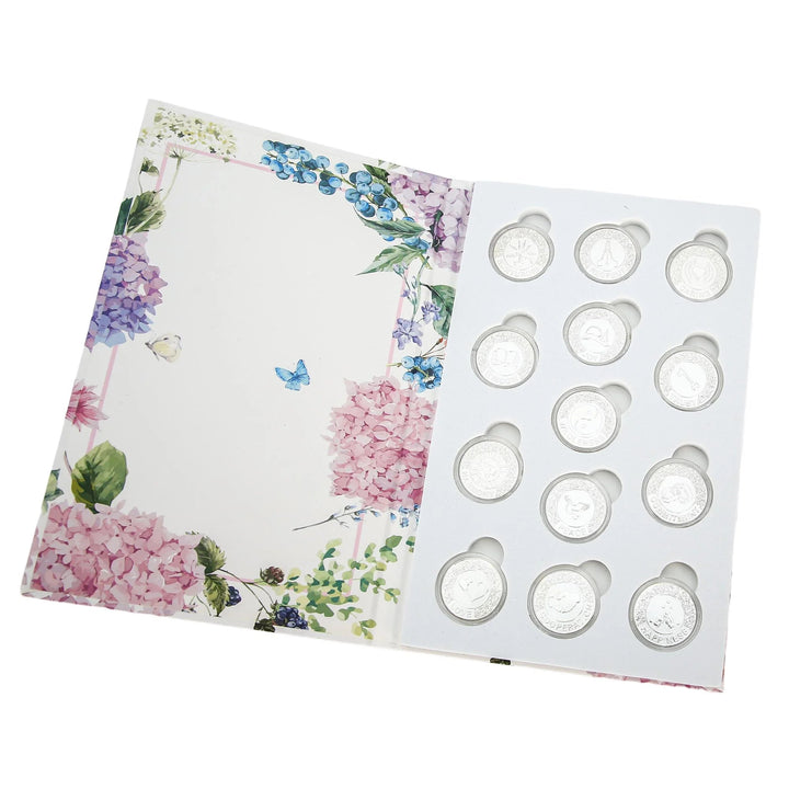 Elegant 13-piece silver wedding unity coins set with unique symbolic designs, beautifully arranged in a floral gift box. Perfect for Catholic wedding ceremonies, Christian marriage rituals, and traditional arras de boda. A meaningful keepsake and timeless gift for newlyweds or anniversaries - tingkucoins.com