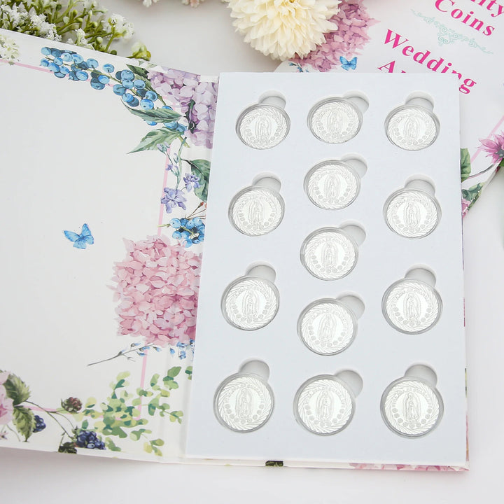 Stunning silver arras wedding coins set, including 13 detailed designs symbolizing love, faith, and unity. Presented in a floral keepsake box, this set is ideal for Catholic and Christian weddings, marriage blessings, or as a memorable gift for couples celebrating their union - tingkucoins.com